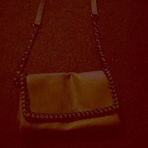A beige hand side purse, it has 2 pockets,